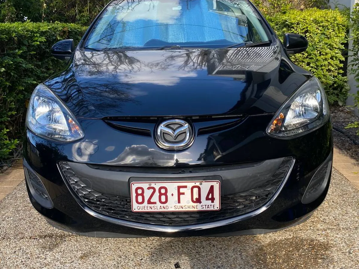 Black Mazda 2 with both headlights restored, Brisbane